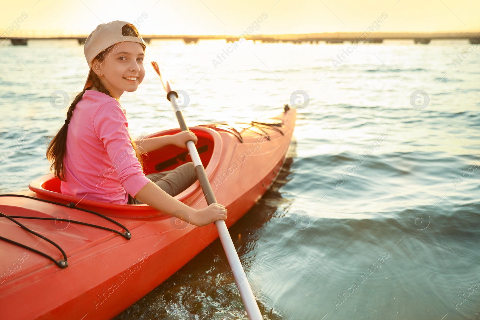 Photo of Happy girl kayaking on river. Summer camp activity