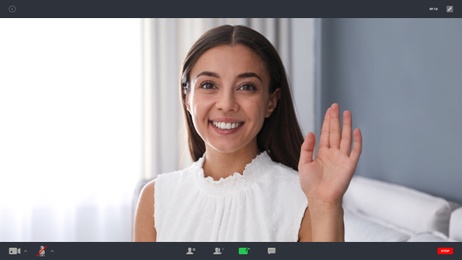 Image of Woman communicating with coworkers from home using video chat, view through camera