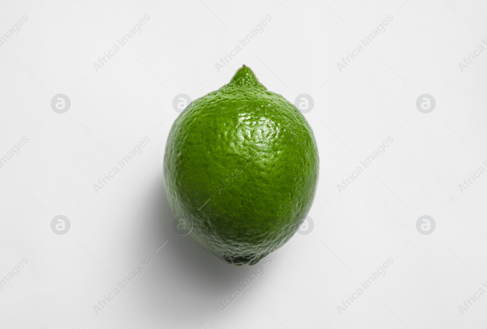 Photo of Fresh juicy lime on white background, top view