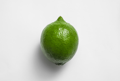 Photo of Fresh juicy lime on white background, top view