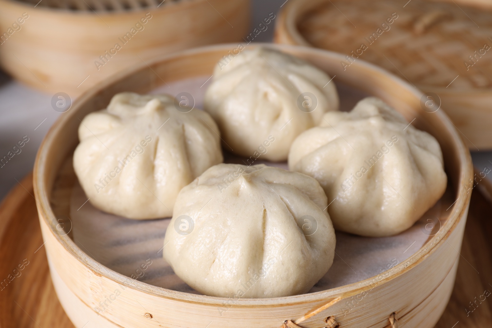 Photo of Delicious bao buns (baozi) on table, closeup