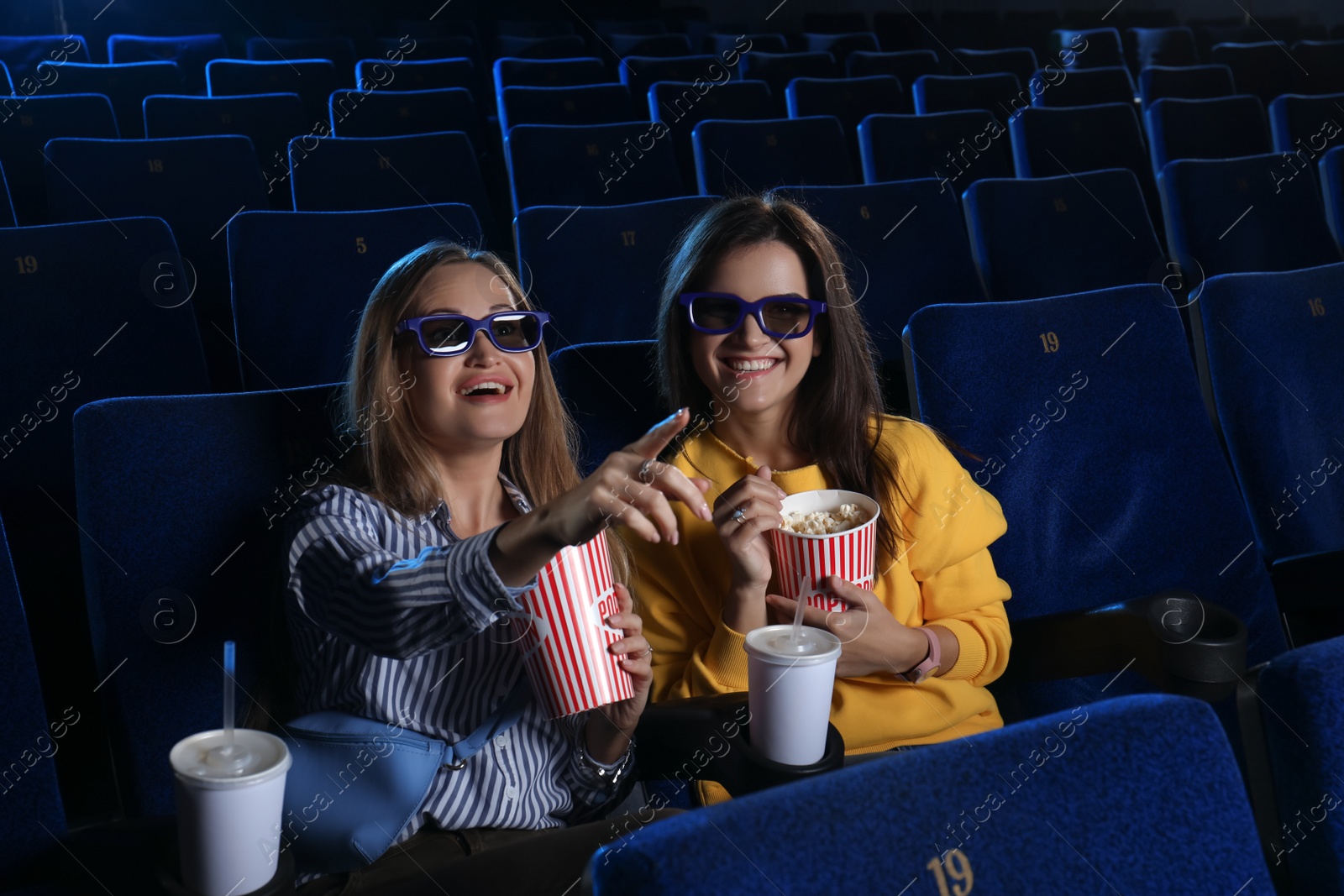 Photo of Young women watching movie in cinema theatre