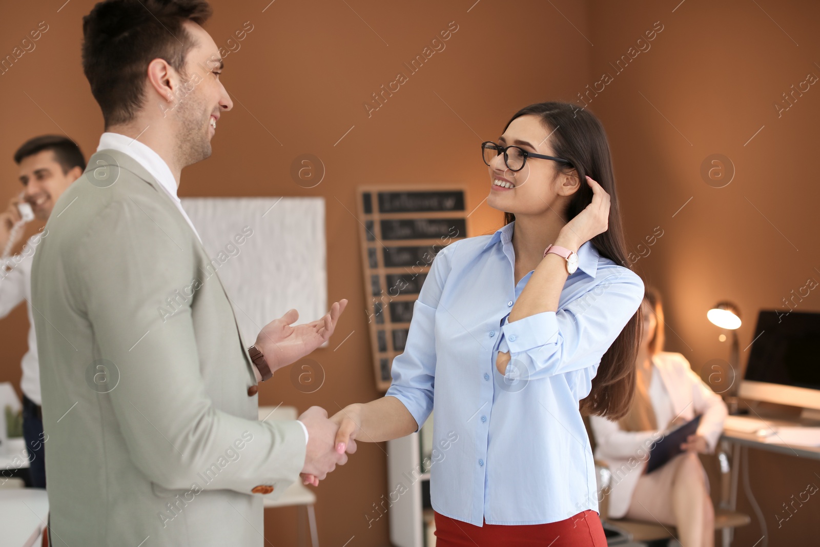 Photo of Human resources manager shaking hands with applicant during job interview in office