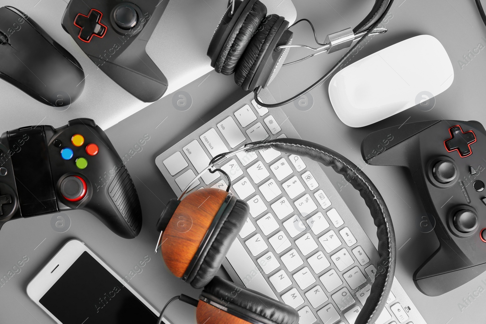 Photo of Gamepads, mice, headphones and keyboard on table