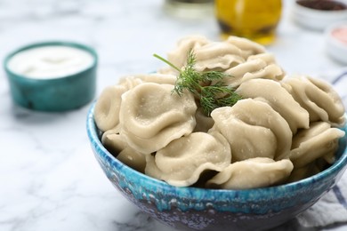 Tasty dumplings in bowl on table, closeup