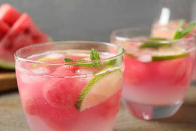 Photo of Tasty refreshing watermelon drink on table, closeup