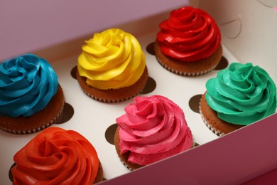 Photo of Different cupcakes with cream in box, closeup