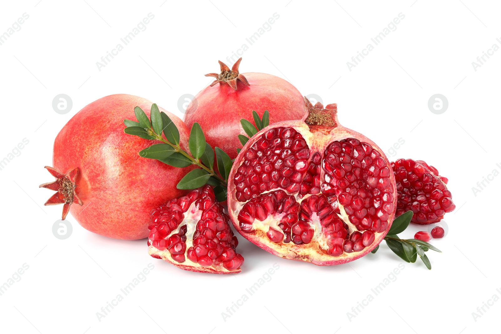 Photo of Fresh pomegranates and branches isolated on white