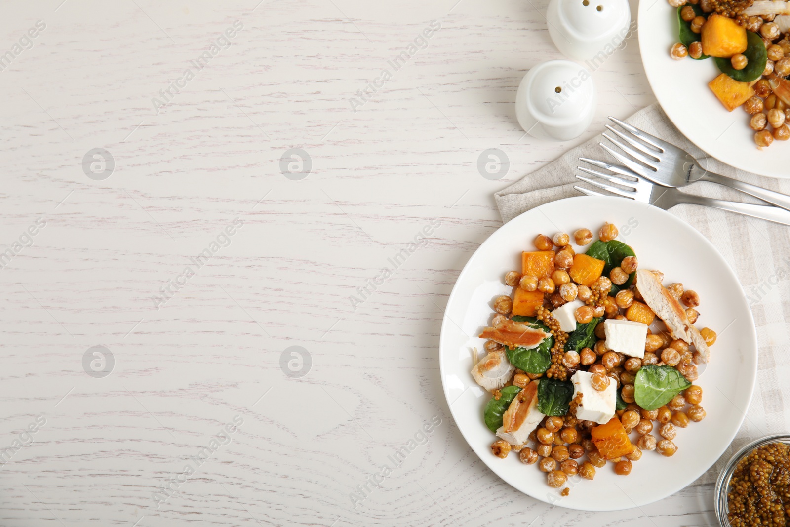 Photo of Delicious fresh chickpea salad served on white wooden table, flat lay. Space for text