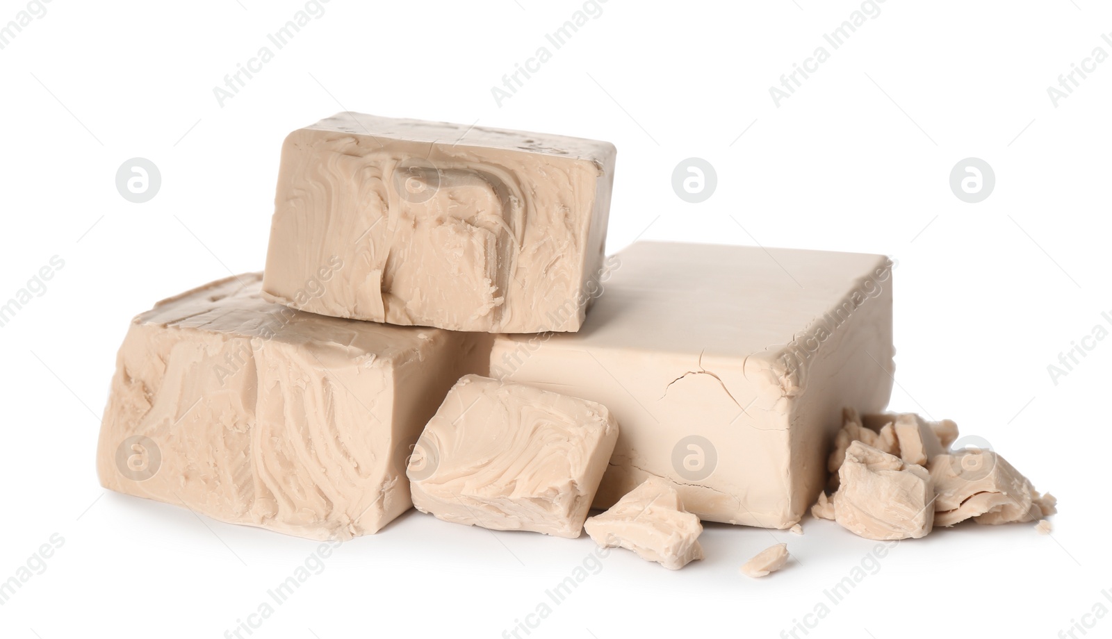 Photo of Pieces of compressed yeast on white background