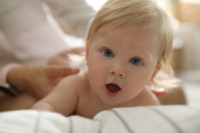 Photo of Mother and her cute little baby at home. Healthy growth