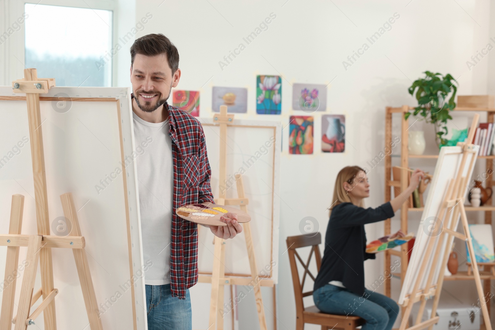 Photo of Students attending painting class in studio. Creative hobby