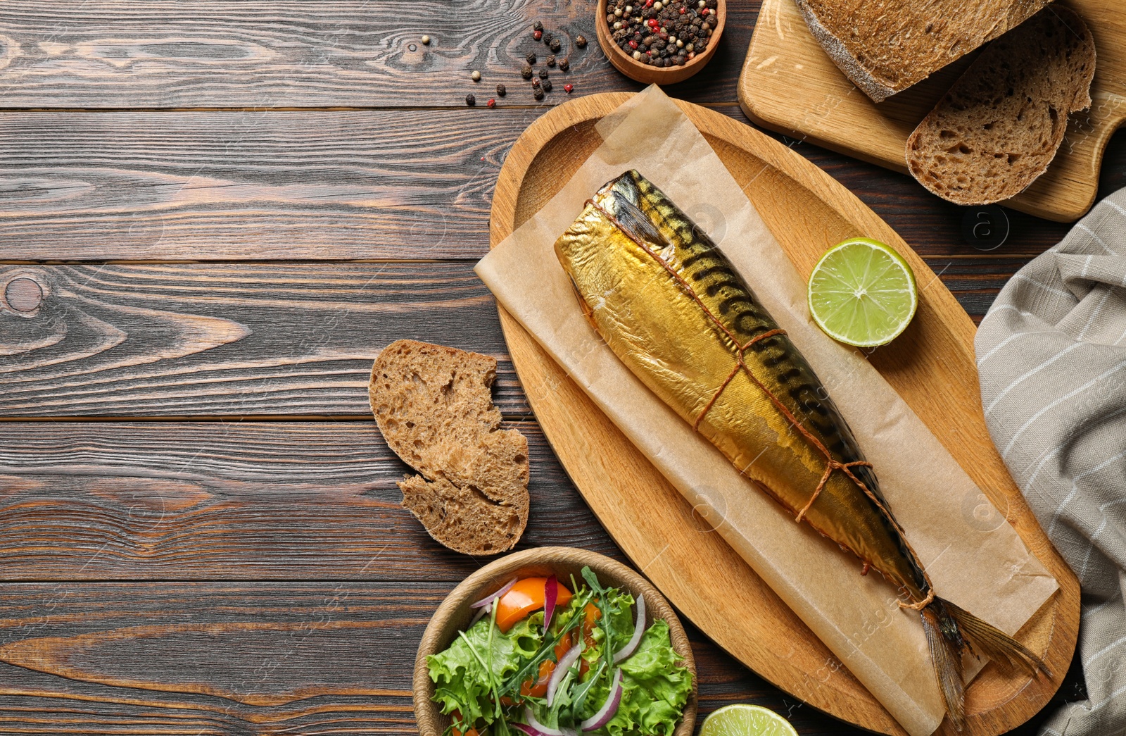 Photo of Flat lay composition with tasty smoked fish on wooden table. Space for text