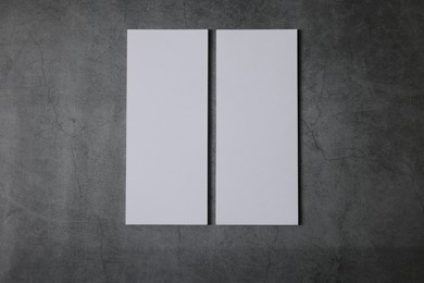 Photo of Blank business cards on grey textured background, top view. Mockup for design