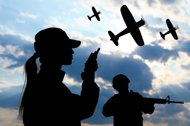Image of Silhouettes of soldiers in uniform and military airplanes patrolling outdoors