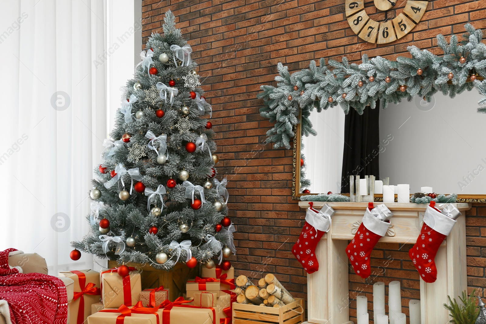 Photo of Stylish interior with beautiful Christmas tree and decorative fireplace