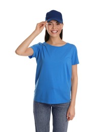 Photo of Young happy woman in blue cap and tshirt on white background. Mockup for design