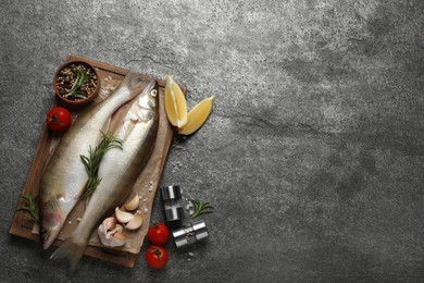 Photo of Fresh raw pike perches and ingredients on grey table, flat lay with space for text. River fish