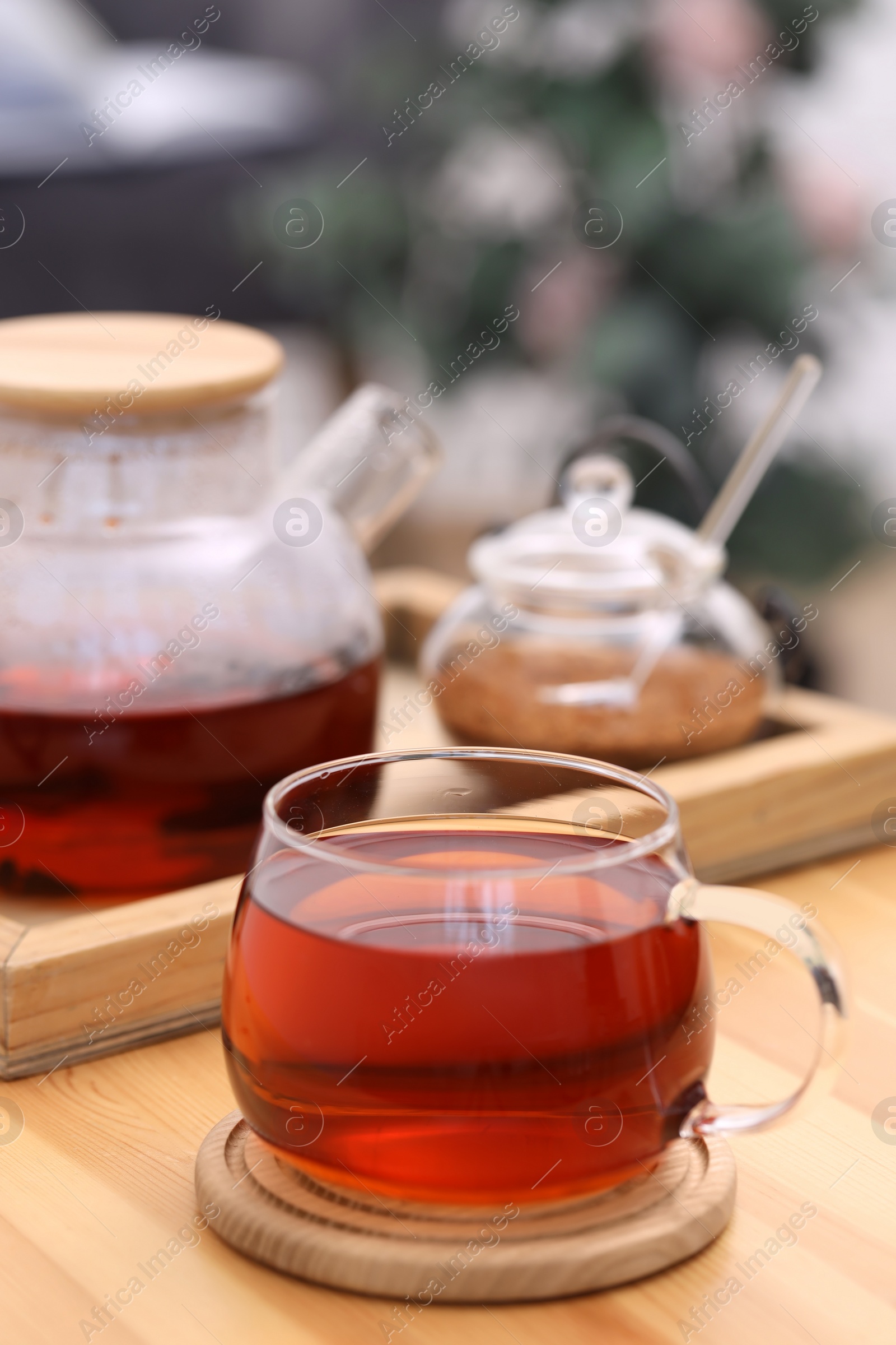 Photo of Cup of aromatic tea on wooden table indoors