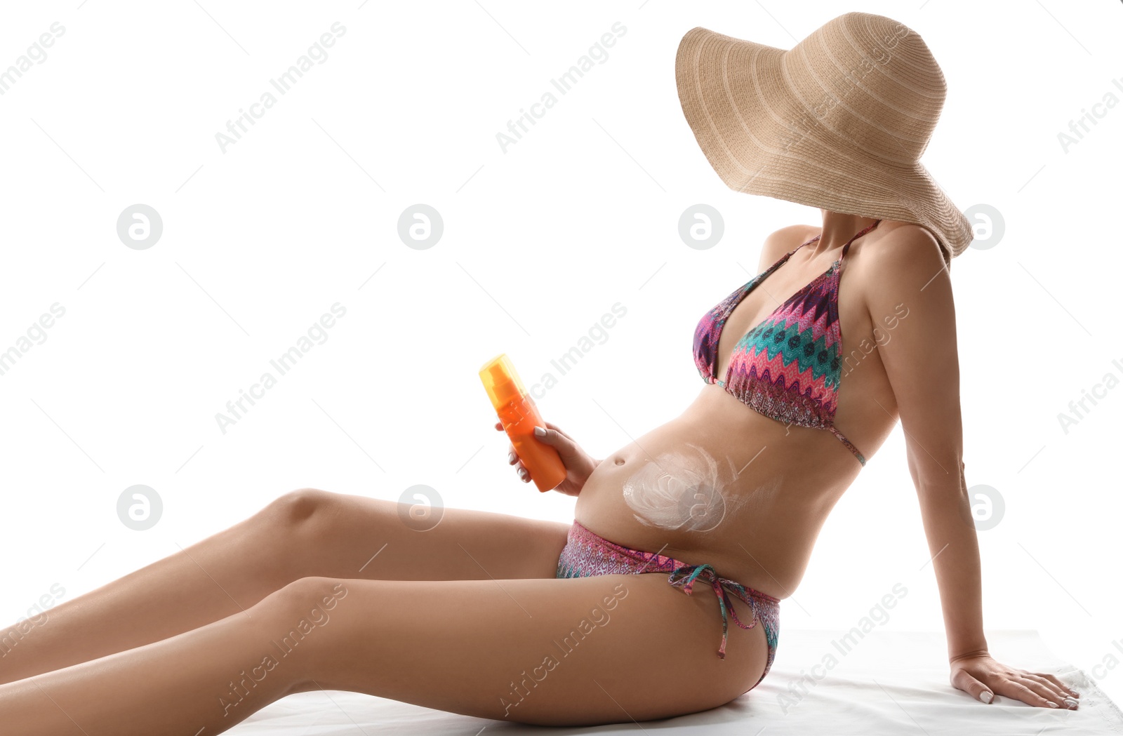 Photo of Pregnant woman with sun protection cream on white background