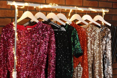 Photo of Collectiondifferent beautiful women's party dresses in showroom. Stylish trendy clothes for high school prom
