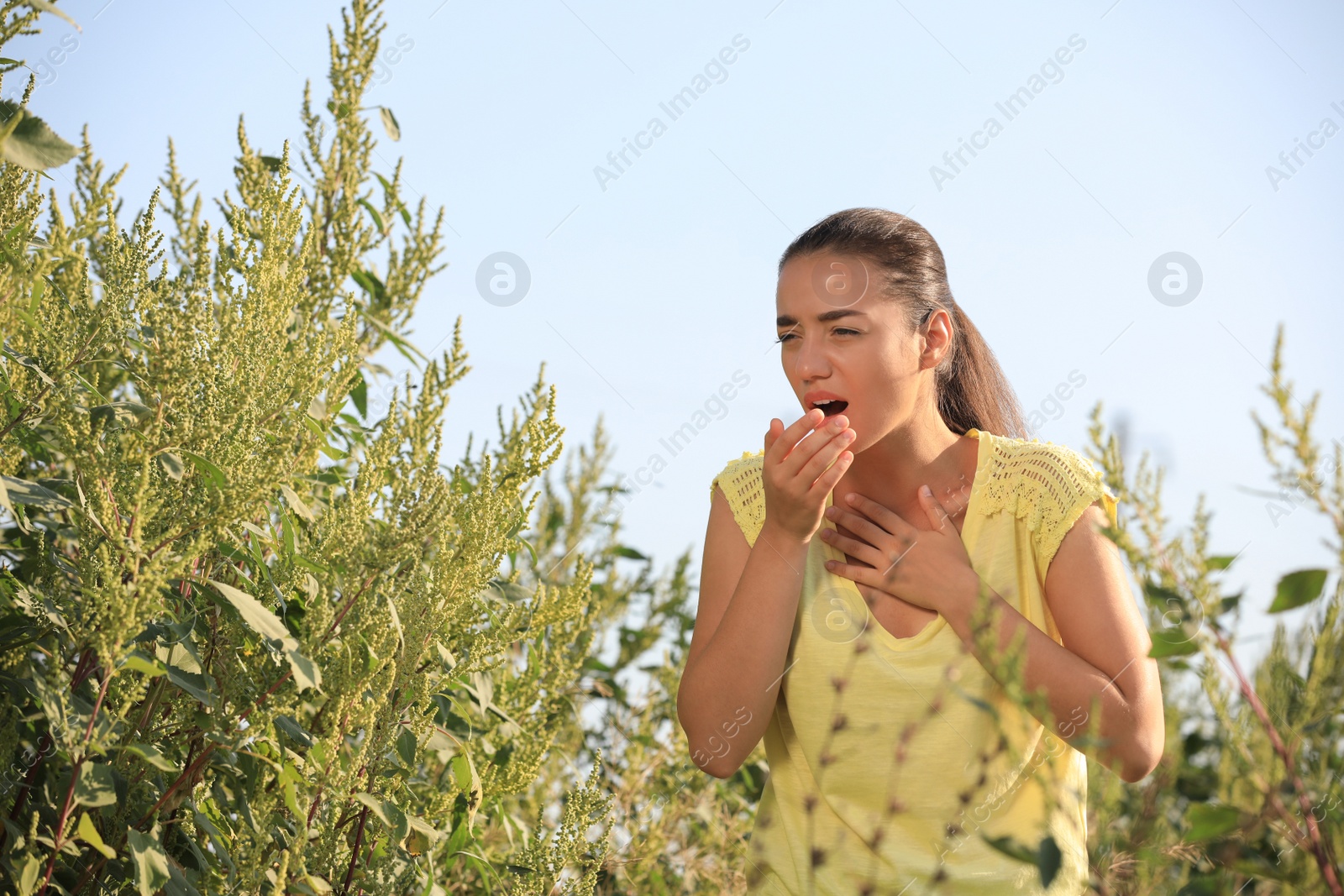 Photo of Young woman suffering from ragweed allergy outdoors