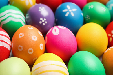 Photo of Colorful Easter eggs with different patterns as background, closeup