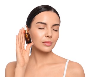 Young woman with bottle of essential oil on white background