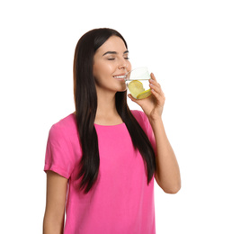 Photo of Beautiful young woman drinking tasty lemon water on white background