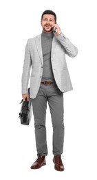 Photo of Handsome bearded businessman with briefcase talking on smartphone against white background