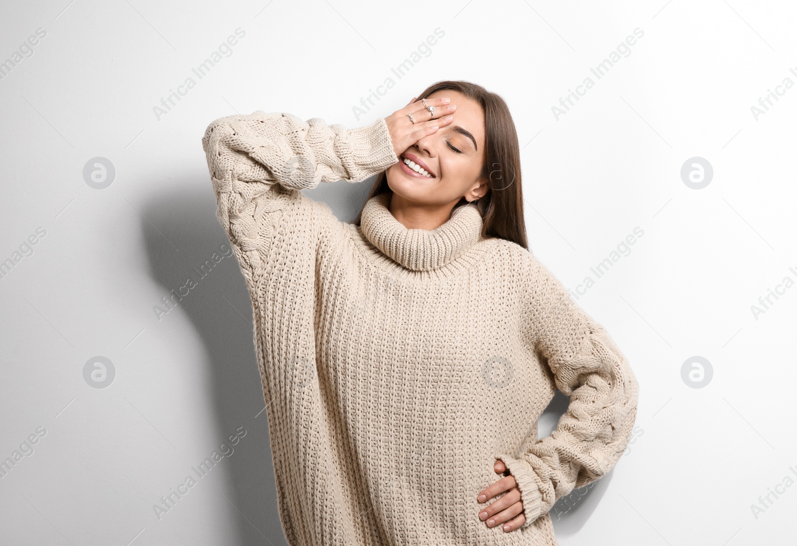 Photo of Beautiful young woman in warm sweater on white background