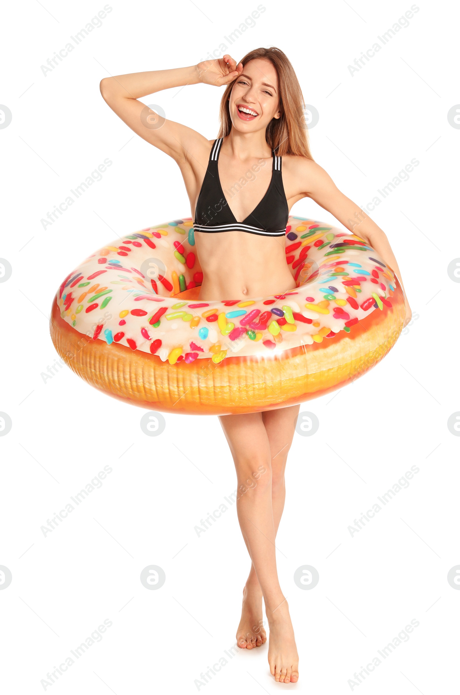 Photo of Beautiful young woman in stylish bikini with doughnut inflatable ring on white background