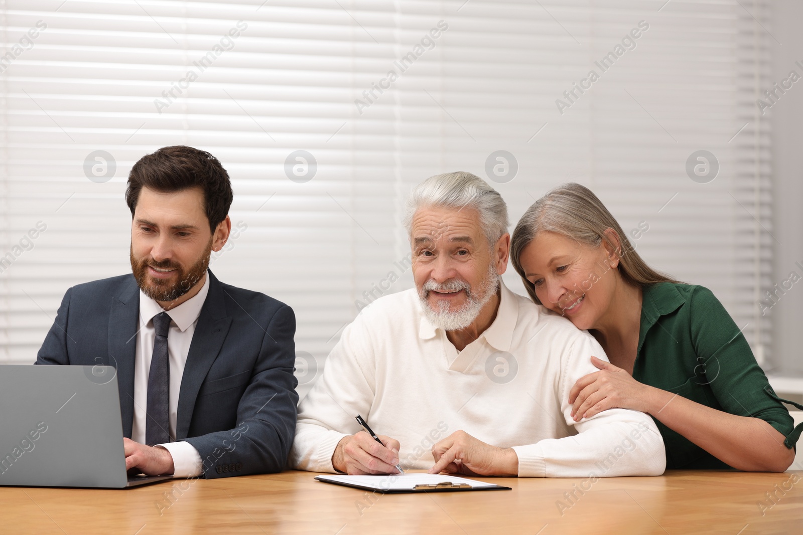 Photo of Notary consulting senior couple about Last Will and Testament in office