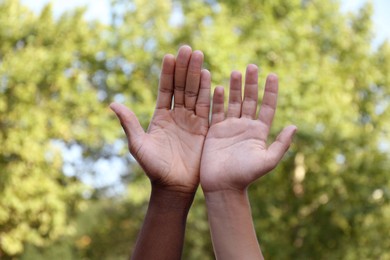 Closeup view of men showing hands outdoors