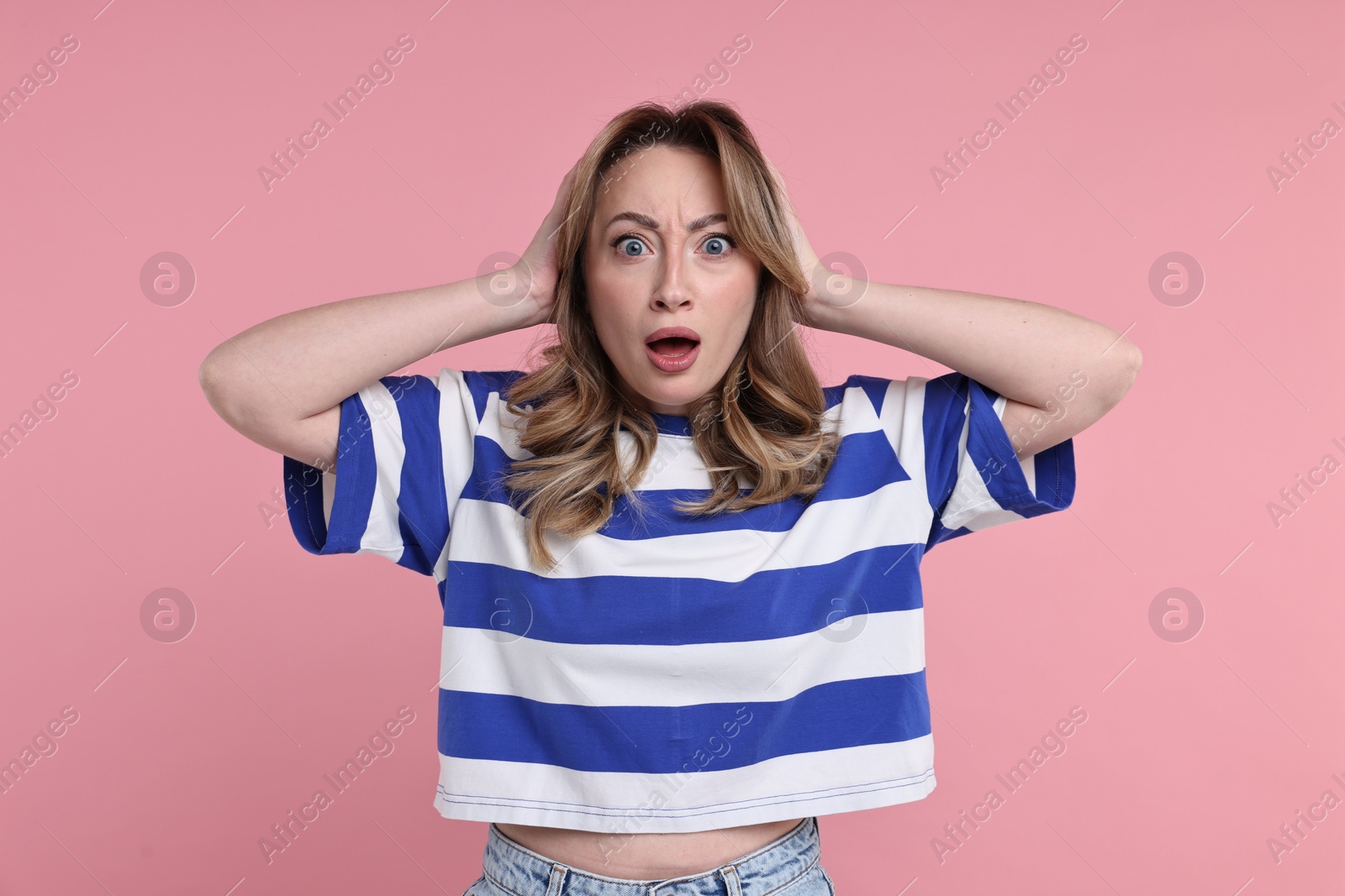 Photo of Portrait of surprised woman on pink background