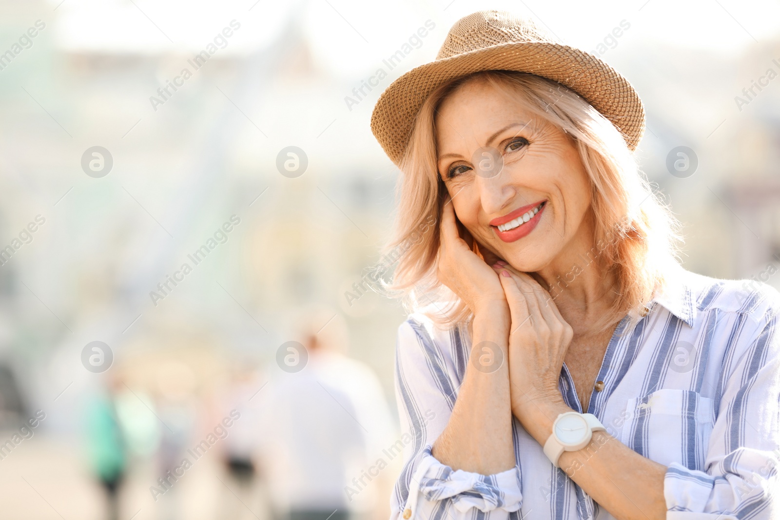 Photo of Portrait of happy mature woman on city street