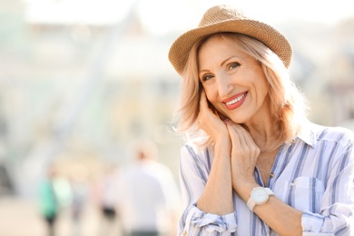 Portrait of happy mature woman on city street