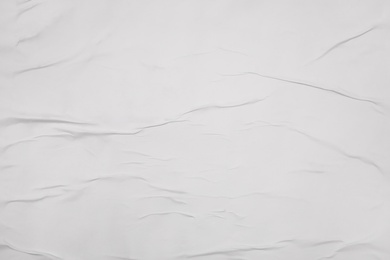 Photo of Top view of white creased blank poster as background, closeup