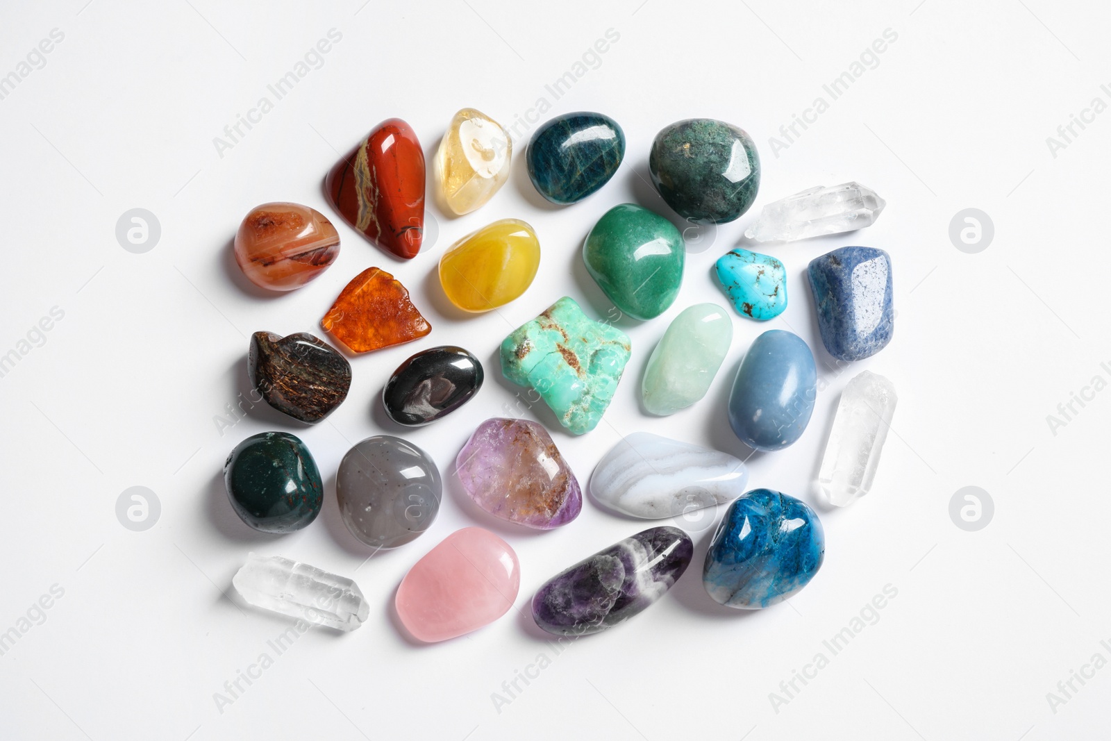 Photo of Different beautiful gemstones on white background, top view