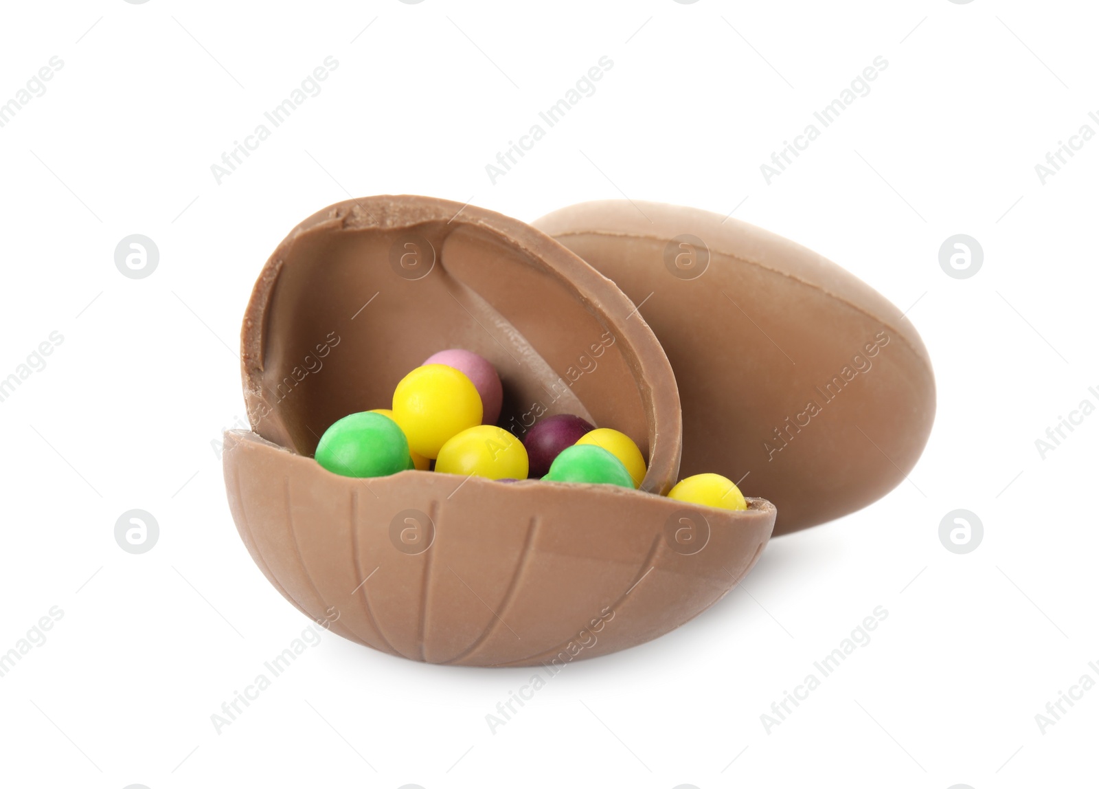 Photo of Tasty chocolate eggs with colorful candies on white background