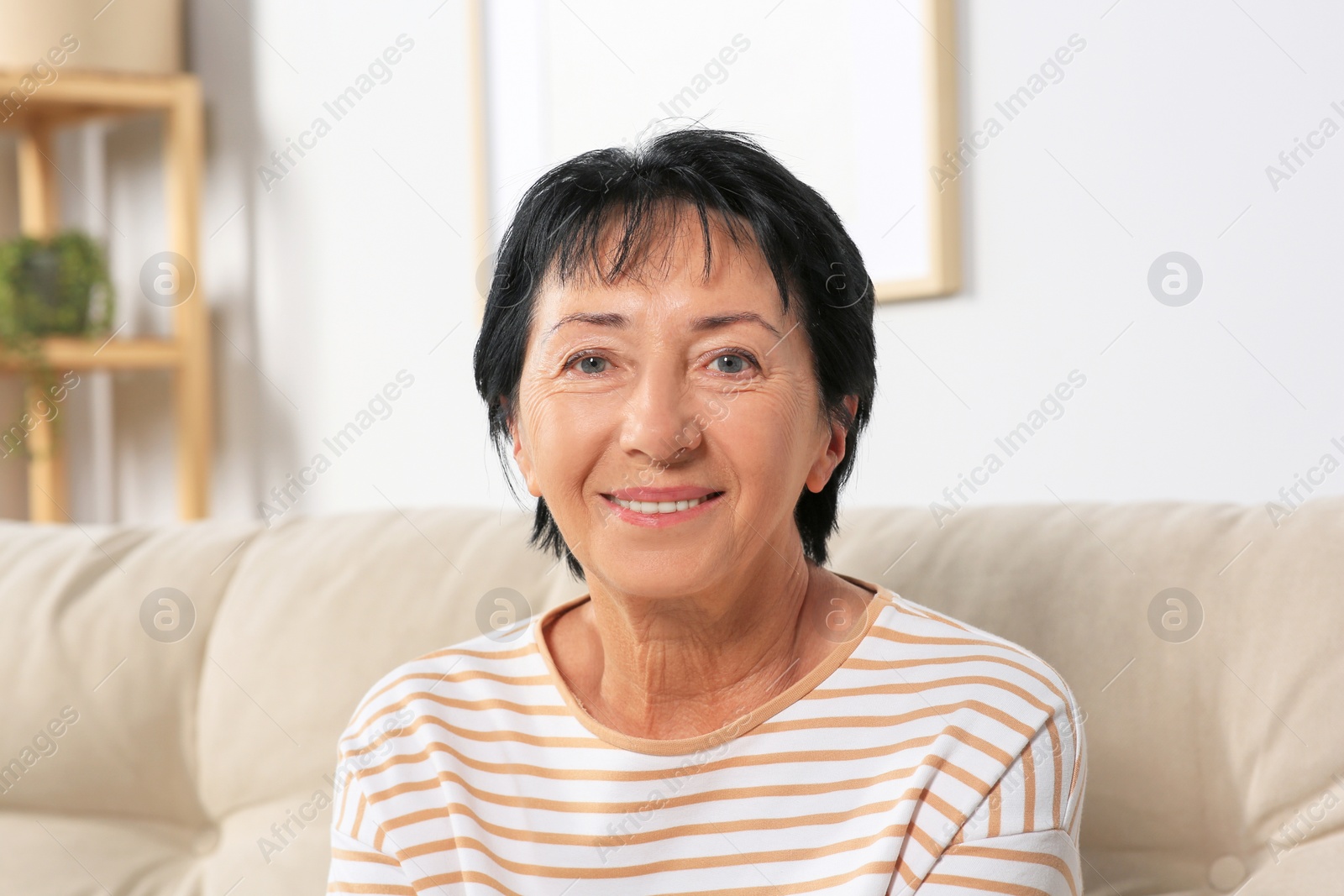 Photo of Portrait of smiling senior woman at home