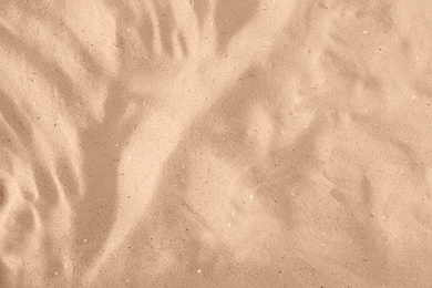 Golden beach sand on sunny day as background