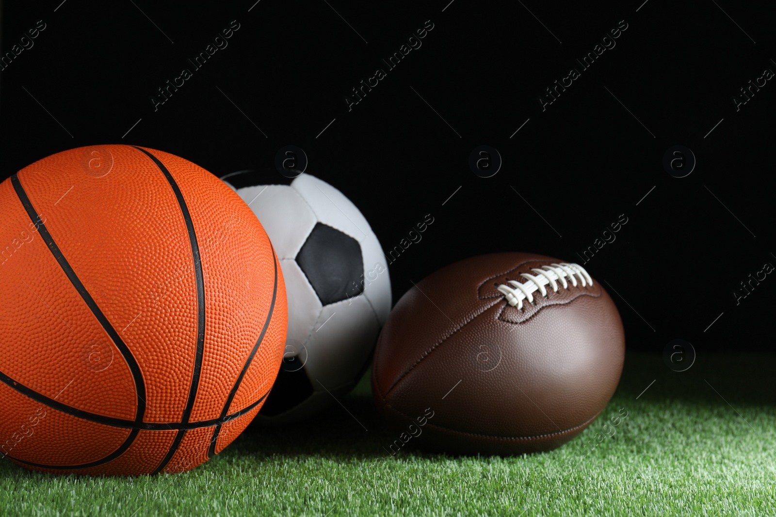 Photo of Set of different sport balls on green grass