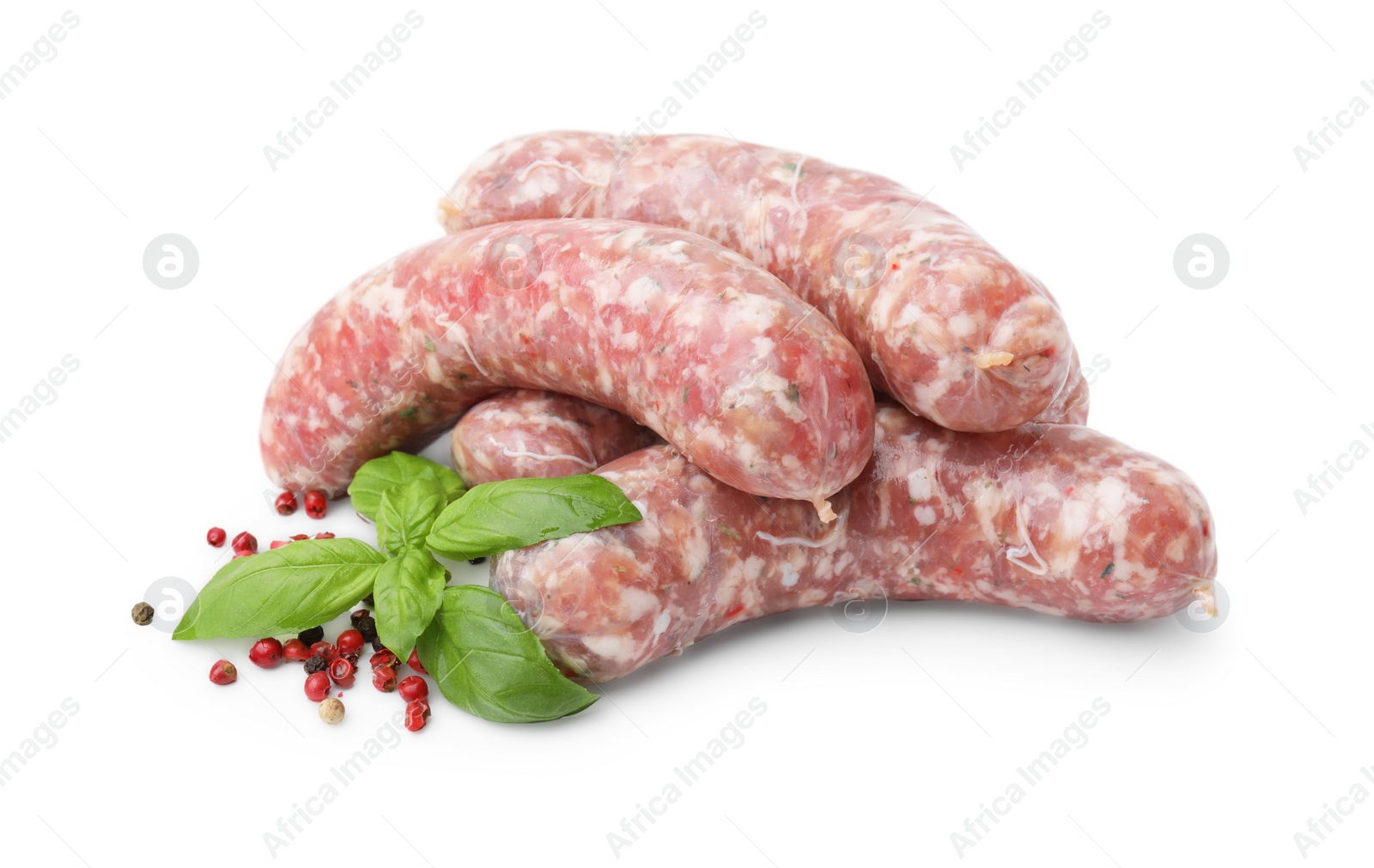 Photo of Raw homemade sausages, basil and spices isolated on white