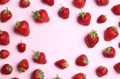 Photo of Tasty ripe strawberries on pink background, flat lay. Space for text