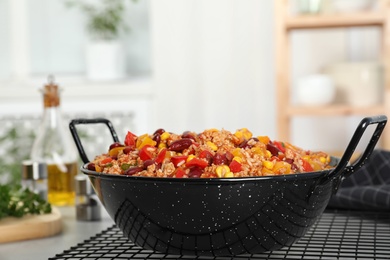 Photo of Pan with tasty chili con carne on gray table