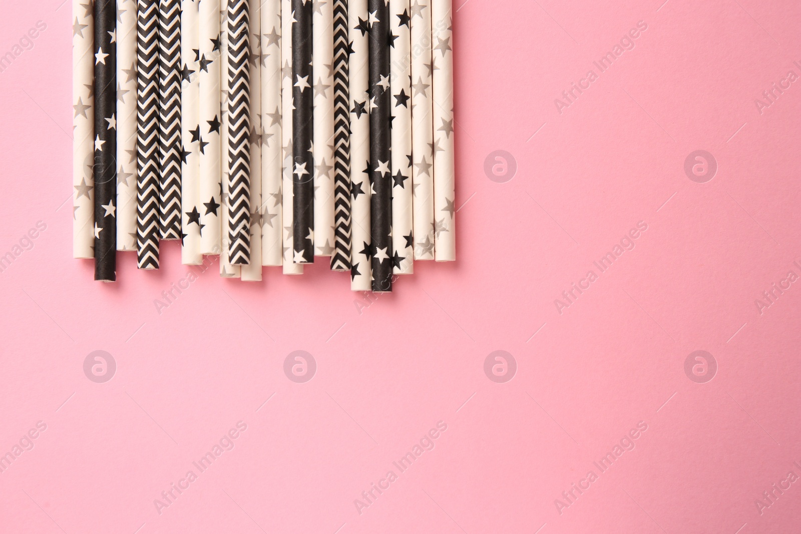 Photo of Many paper drinking straws on pink background, flat lay. Space for tex