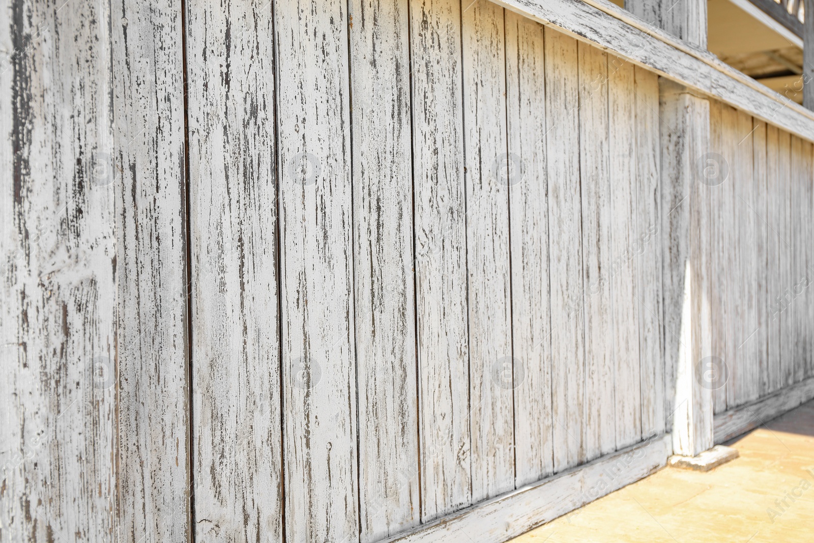 Photo of Closeup view of white wooden fence outdoors on sunny day