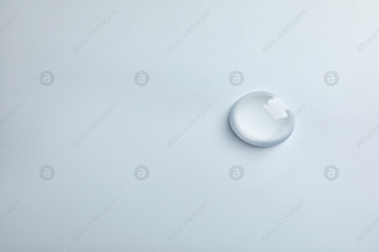 Photo of Beautiful clean water drop on light background
