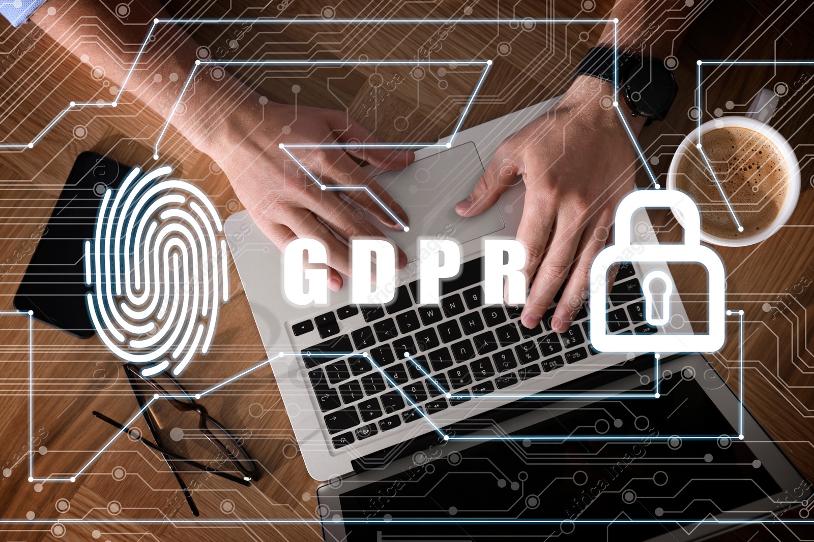 Image of General Data Protection Regulation. Man working with laptop, top view. GDPR abbreviation, fingerprint, padlock and circuit board pattern